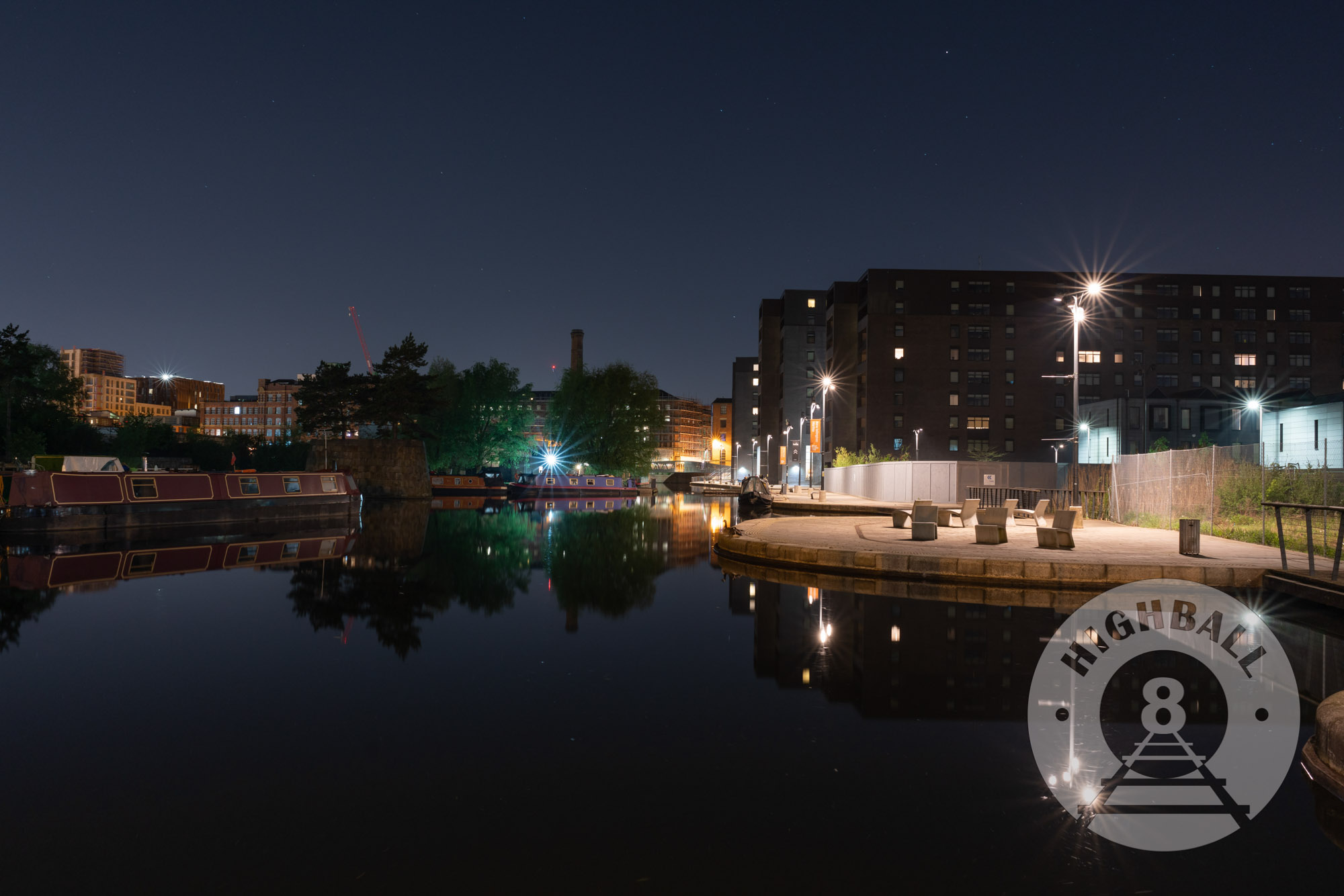 Night photo of canal boats in a marina, New Islington, Manchester, UK, 2018.