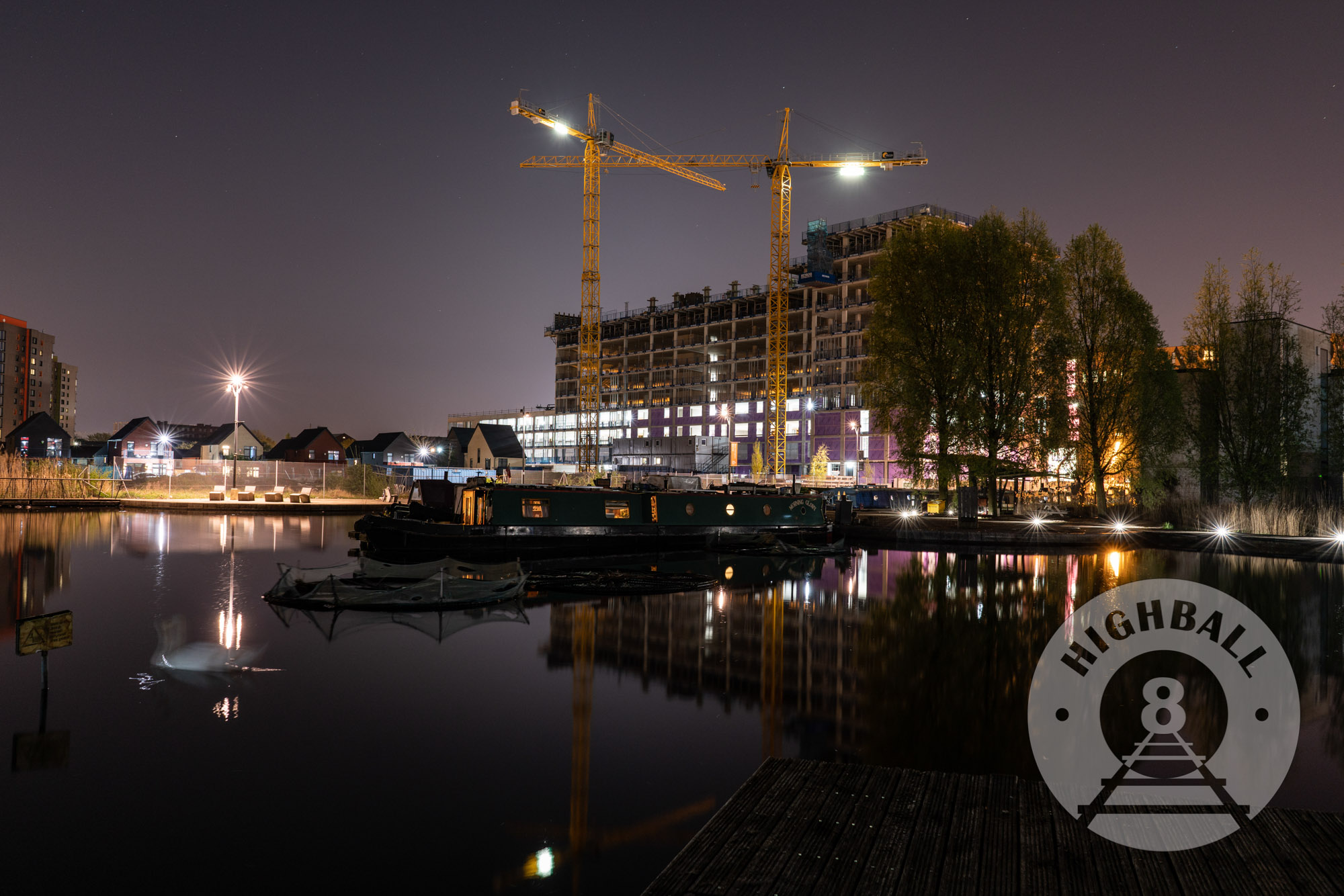 Night photo of canal boats in a marina, New Islington, Manchester, UK, 2018.